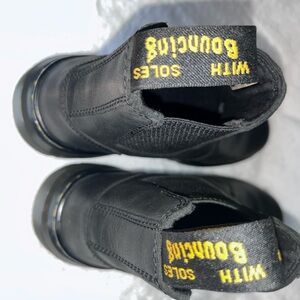 Black Slip-On Boots with Rugged Sole and Yellow Text
